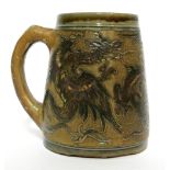 MARTIN BROTHERS, BRITISH, ESTABLISHED 1873, A STONEWARE GLAZED TANKARD The incised decoration in the