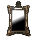 A 19TH CENTURY CARTOUCHE FRAMED MIRROR With shell pediment and raised decoration, detailed on a