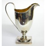 A GEORGIAN SILVER CLASSICAL HELMET FORM CREAM JUG With gilt interior, hallmarked John Merry, London,