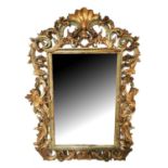 A LARGE EARLY 19TH CENTURY ITALIAN MIRROR The heavily carved pierced giltwood and painted frame in