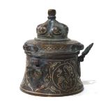 AN ANTIQUE PERSIAN BRONZE AND SILVER CEREMONIAL VESSEL Having a done form lid and silver wire