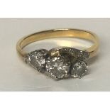 AN EARLY 20TH CENTURY YELLOW METAL PLATINUM SET THREE STONE DIAMOND RING Size m/n