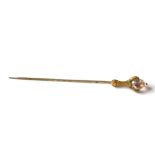 A 19TH CENTURY YELLOW METAL AND GEM SET TIE STICKPIN Eagle claw set with oval cut light pink