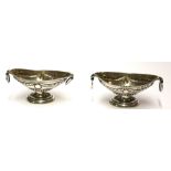 A PAIR OF VICTORIAN SILVER CLASSICAL NAVETTE FORM SALTS With ring handles and embossed decoration,