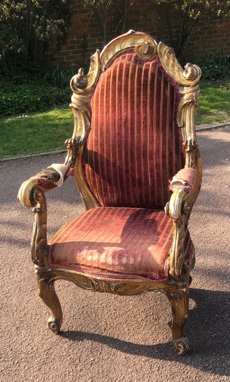 AN 18TH CENTURY ITALIAN OPEN ARMCHAIR The carved giltwood frame of organic form with over