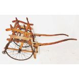 AN EARLY 20TH CENTURY BEECHWOOD TRAP/DOG CART With single seat, on iron spoked wheels. (104cm x 43cm