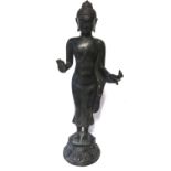 A CHINESE BRONZE STATUE OF A STANDING BUDDHA Patinated finish with one palm hand showing, raised