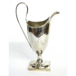 A GEORGIAN SILVER CLASSICAL HELMET FORM CREAM JUG Engraved floral swags on square base. (approx