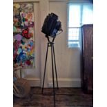 A PAIR OF VINTAGE EBONISED STEEL STUDIO LIGHTS, CIRCA 1940 On a metal tripod base. (overall 205cm)