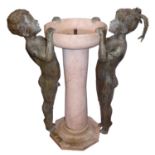 A BRONZE AND ROUGE MARBLE WATER FOUNTAIN Figured with two children peering into it. (w 88cm x h
