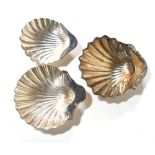 A COLLECTION OF THREE EARLY 20TH CENTURY SILVER SHELL FORM BUTTER DISHES Including hallmark 1904. (