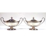 A PAIR OF GEORGE III SILVER NAVETTE FORM TUREENS AND COVERS Having twin handles and engraved