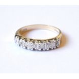 A VINTAGE 9CT GOLD AND DIAMOND HALF ETERNITY RING The arrangement of seven round cut diamonds. (