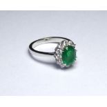 AN 18K WHITE GOLD RING SET WITH A 1.98 EMERALD Surrounded by .60 diamonds (size N). weight approx
