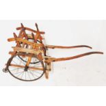 AN EARLY 20TH CENTURY BEECHWOOD TRAP/DOG CART With single seat, on iron spoked wheels. (104cm x 43cm