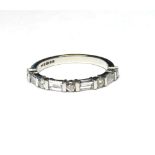 AN 18K WHITE GOLD HALF ETERNITY RING Set with nine baguette and round cut diamonds (size L/M).