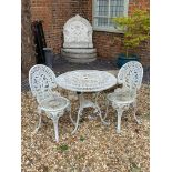 A VICTORIAN STYLE PAINTED METAL CIRCULAR GARDEN TABLE Complete with two matching chairs.