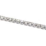 AN IMPRESSIVE 18K WHITE GOLD TENNIS BRACELET Set with 16.28ct of round cut diamonds. (18cm) weight