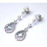 A PAIR OF 18CT WHITE GOLD AND DIAMOND DROP EARRINGS Set with 3.45ct pear cut aquamarines. (diamond
