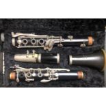 AN EARLY 20TH CENTURY VINTAGE EBONISED SIX KEY CLARINET In original black velvet fitted presentation