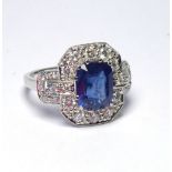 A 14K WHITE GOLD RING SET WITH A 3.63CT PRINCESS CUT SAPPHIRE SURROUNDED BY DIAMONDS (size M).