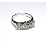 AN 18K WHITE GOLD RING SET WITH THREE ROUND CUT DIAMONDS (size M). (diamond weight 2.44ct) weight