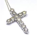 A 14CT WHITE GOLD CRUCIFIX SET WITH 3.6 CT OF DIAMONDS On silver chain. (3.2cm x 2.2cm) (weight