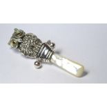 A SILVER AND MOTHER OF PEARL NOVELTY CHILD'S TEETHING RATTLE Modelled as an owl with glass eyes