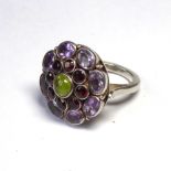 AN UNUSUAL CONTINENTAL SILVER AND GEM SET CLUSTER RING The arrangement of farmers edged with