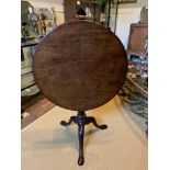 A GEORGE III SOLID MAHOGANY BIRDCASE TILT TOP TABLE Supported on a turned column on three cabriole