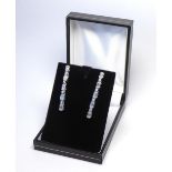 A PAIR OF 18K WHITE GOLD DROP EARRINGS Set with 1.6ct of baguette and round cut diamonds. (4.1cm)