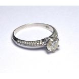 AN 18K WHITE GOLD SOLITAIRE RING SET WITH A 1CT DIAMOND On diamond shoulders. weight approx 3gm.