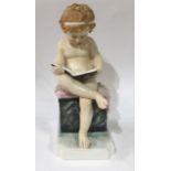 AN EARLY 20TH CENTURY GERMAN VOLKSTADT PORCELAIN FIGURE Seated child reading a book, marked to