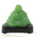 A 20TH CENTURY CHINESE CARVED JADE BUDDHA Seated pose with hardwood base. (approx 5cm)