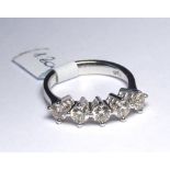 AN 18CT WHITE GOLD RING Set with five round cut diamonds (size N). (1.2ct) weight approx 5gm. Colour