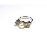 A VINTAGE 18CT WHITE GOLD, DIAMOND AND PEARL RING The single pearl flanked by diamonds in a bow form