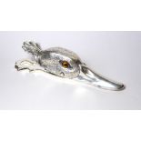 A SILVER PLATED NOVELTY LETTER CLIP Modelled as a bird's head with hinged beak and glass set