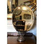 A RARE SILVER PLATE COUNTER TOP HAT MIRROR With carrying handle above a circular bevelled plate