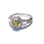 AN 18CT WHITE GOLD NATURAL YELLOW DIAMOND AND DIAMOND RING The single stone edged with round cut