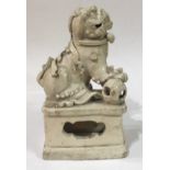 A CHINESE LATE MING DYNASTY, 1369 - 1644, BLANC DE CHINE PORCELAIN FIGURE OF A TEMPLE LION In seated