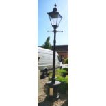 A VICTORIAN STYLE CAST IRON AND COMPOSITION LAMP POST With Westminster style lantern above T-bar