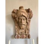 (43cm x A 19TH CENTURY CARVED WOOD WALL BRACKET IN THE FORM OF A ROMAN SOLIDER. 36cm x 22cm)