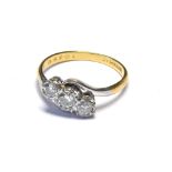 A VINTAGE 18CT GOLD AND DIAMOND THREE STONE DIAMOND RING The arrangement of graduating round cut