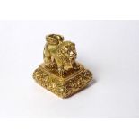 A GOLD PLATED NOVELTY FIGURAL FOB SEAL Surmounted with a lion and engraved family crest to base. (