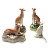 STAFFORDSHIRE, FOUR MINIATURE FIGURES OF GREYHOUNDS. (largest 10cm)