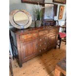 AN 18TH CENTURY OAK DRESSER BASE With three drawers over cupboard doors. (90cm x 50cm x 147.5cm)