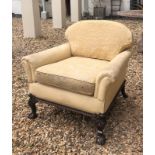 AN EARLY 20TH CENTURY MAHOGANY AND FAUX CREAM LEATHER UPHOLSTERED GENTLEMEN'S LIBRARY ARMCHAIR