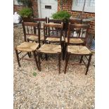 A SET OF SIX LATE VICTORIAN BEECHWOOD DINING CHAIRS With spindle backs and rush seats.