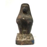 AN EGYPTIAN TERRACOTTA FIGURE OF A MONKEY In seated pose with feathered headdress. (approx 18cm)