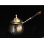 A GEORGIAN SILVER BRANDY SAUCEPAN Having a themed wooden handle, hallmarked WS, London, 1789. (